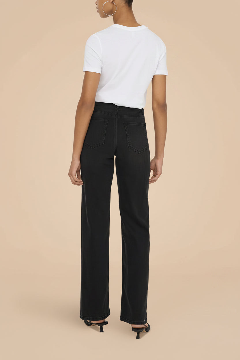 front view of a woman wearing Alatri Black Stretch High-Waisted Denim Pants from La petite garçonne