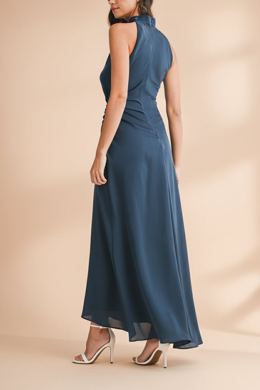 Back view of a woman wearing the Alberta Navy Maxi Dress with a high neckline from Boutique 1861