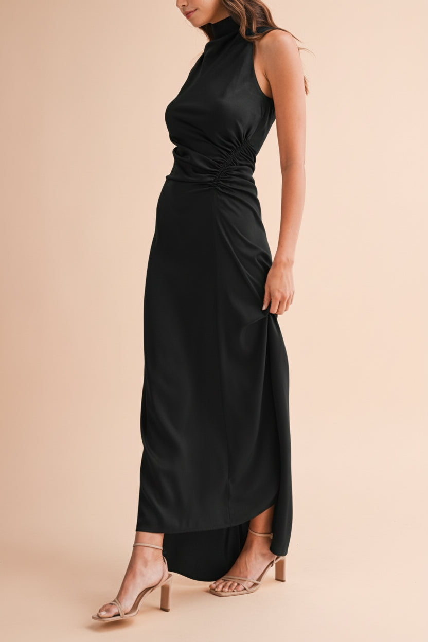 Side view of a woman wearing the Alberta Black Maxi Dress with a high neckline from Boutique 1861.