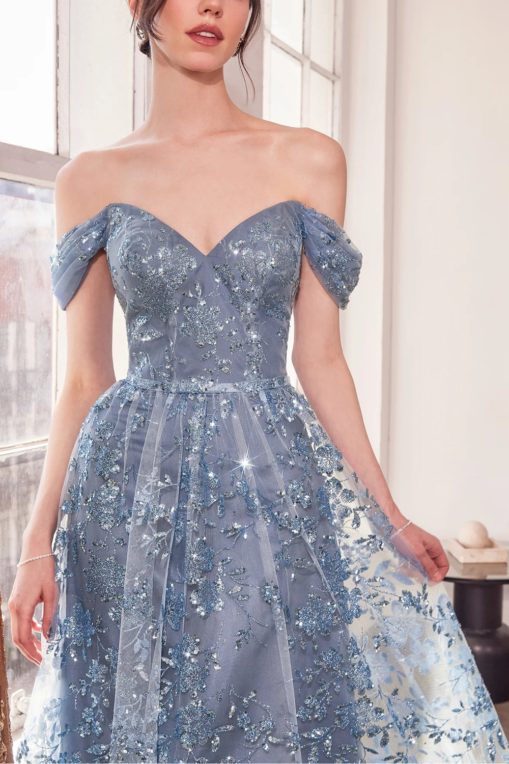 close-up of women wearing Alienor Blue Grey Glittery Off the Shoulder Maxi Dress from Boutique 1861