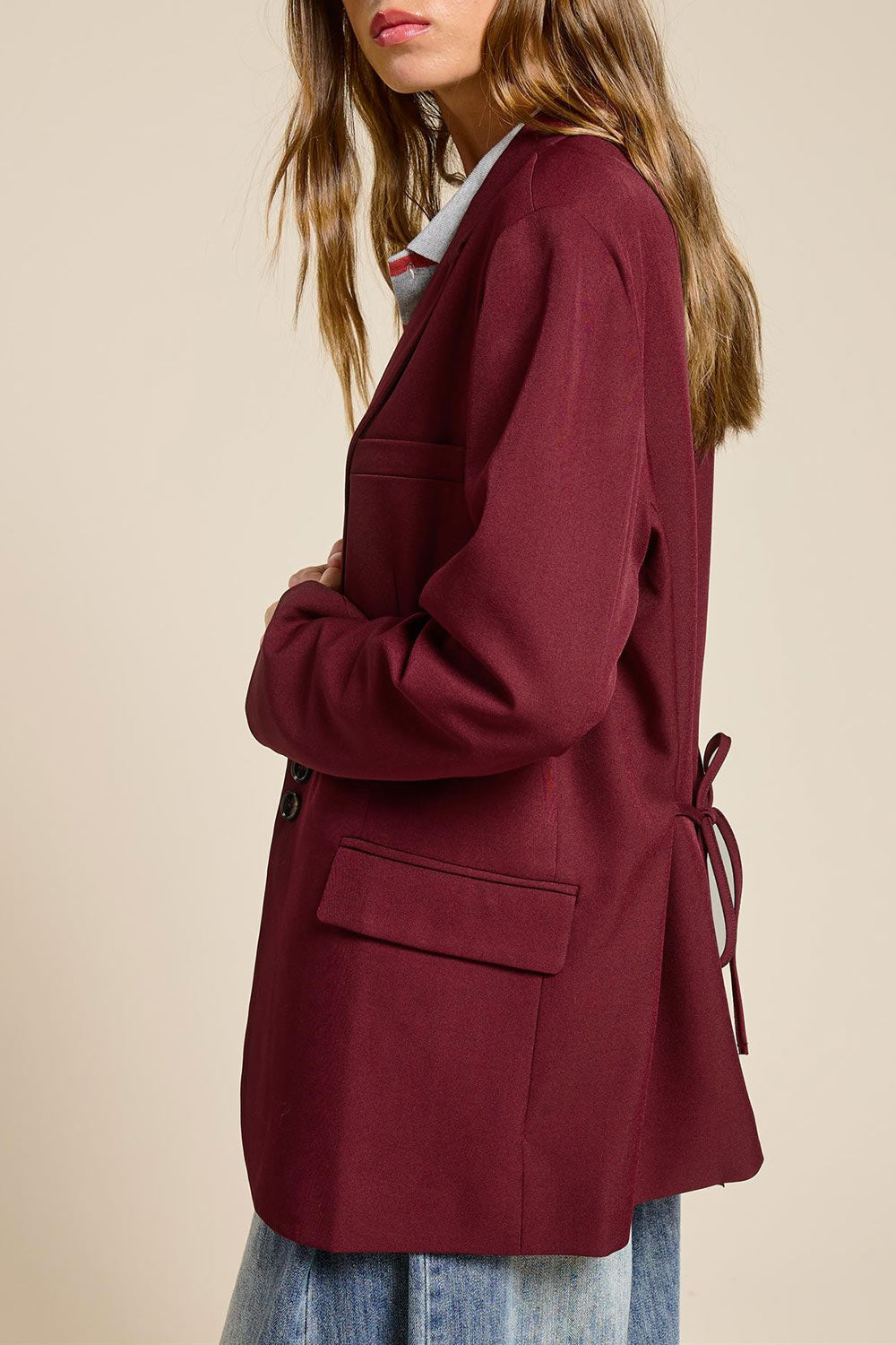 side view of a woman wearing Aosta Burgundy Oversized Blazer with Back-Tie from La petite garçonne