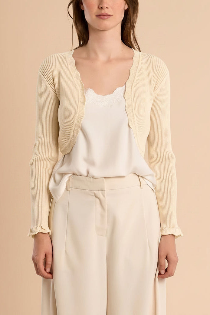 Woman wearing Averie Beige Cropped Knit Bolero with Scalloped Edges from boutique 1861.