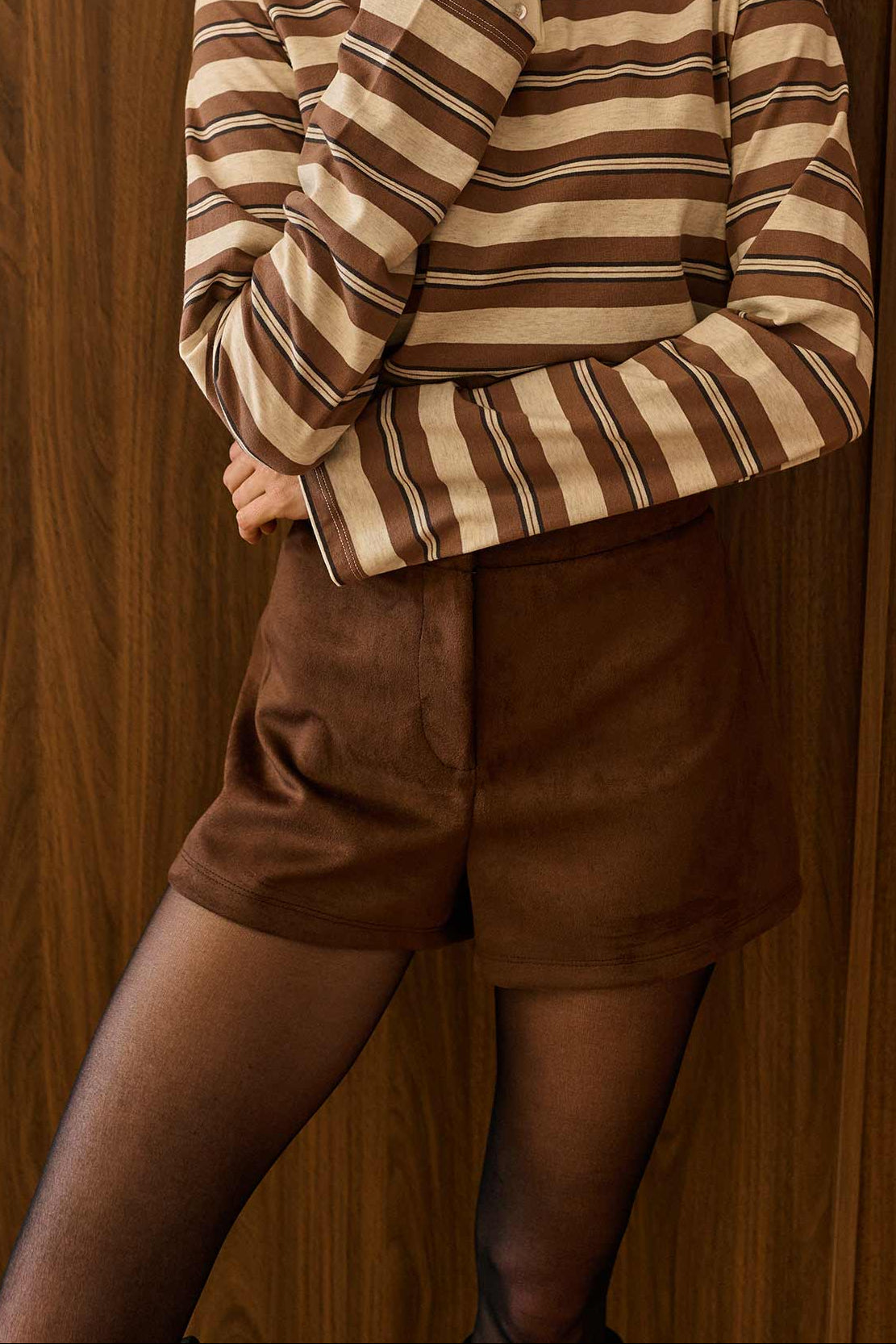 view of a woman wearing Dailystory Enya Brown Faux Suede High-Waisted Shorts from La petite garçonne