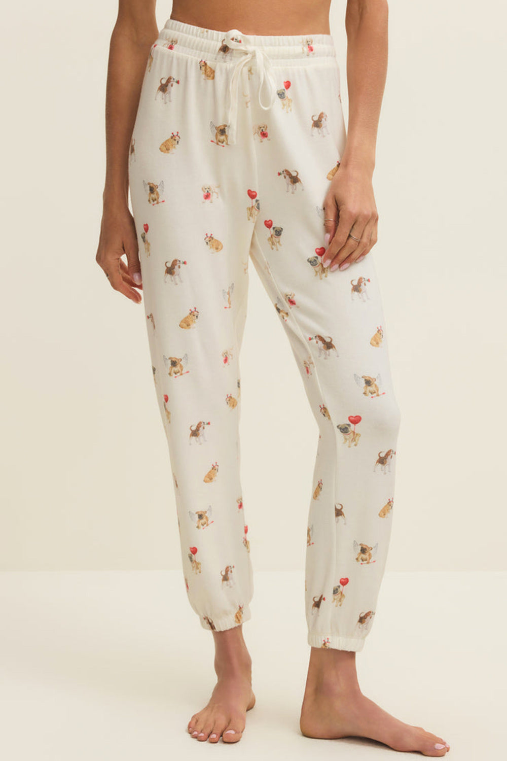 front of a woman wearing Ballari White Jogger Pants with Dog Print from La petite garçonne