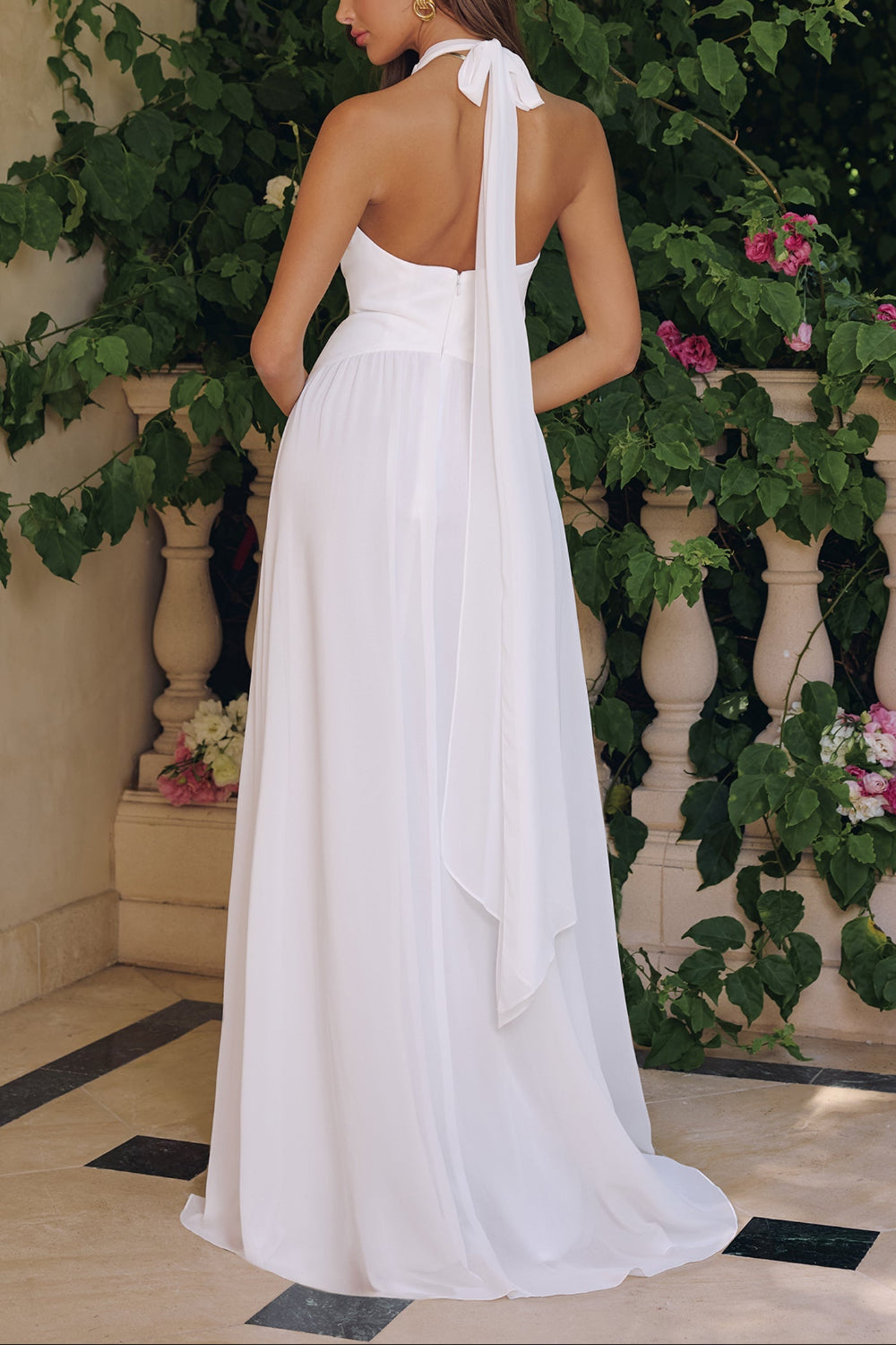 Backview of a Woman wearing Bayley, a white halter neck gown from Boudoir 1861