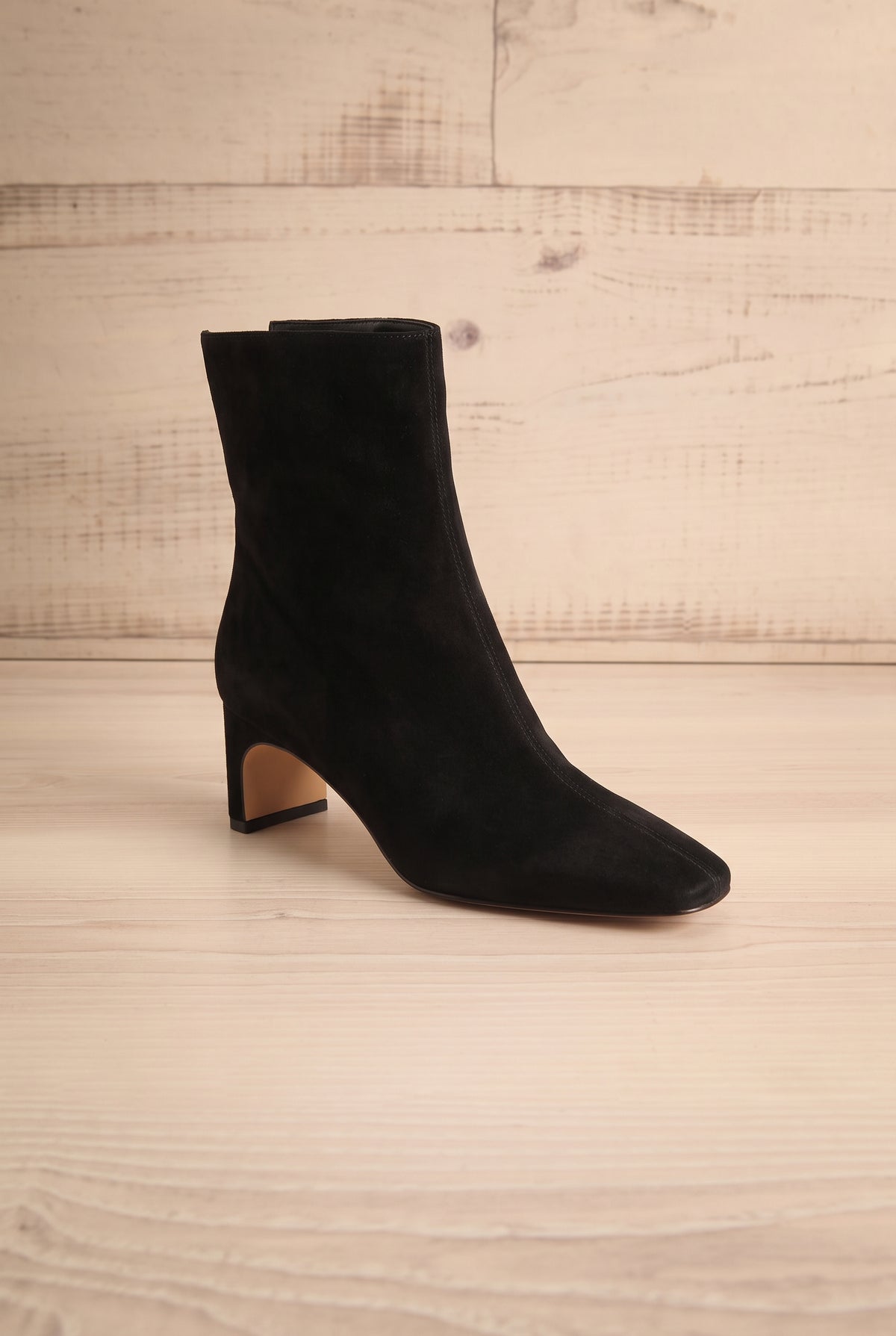Profile view of a single pointed-toe Bennet Black Leather Ankle Boot from Dolce Vita at la petite garçonne in Montreal