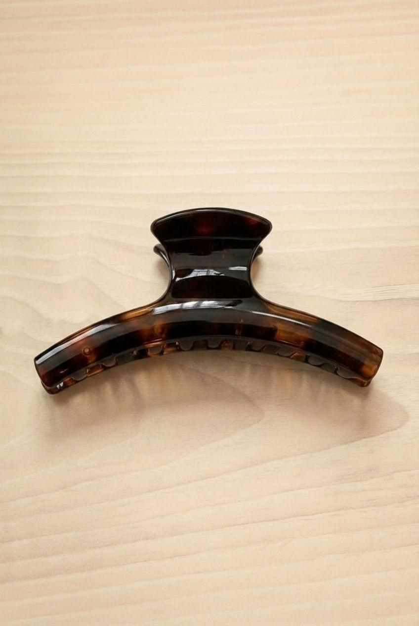 A large hair clip named Biscuit Tortoise on a wood background