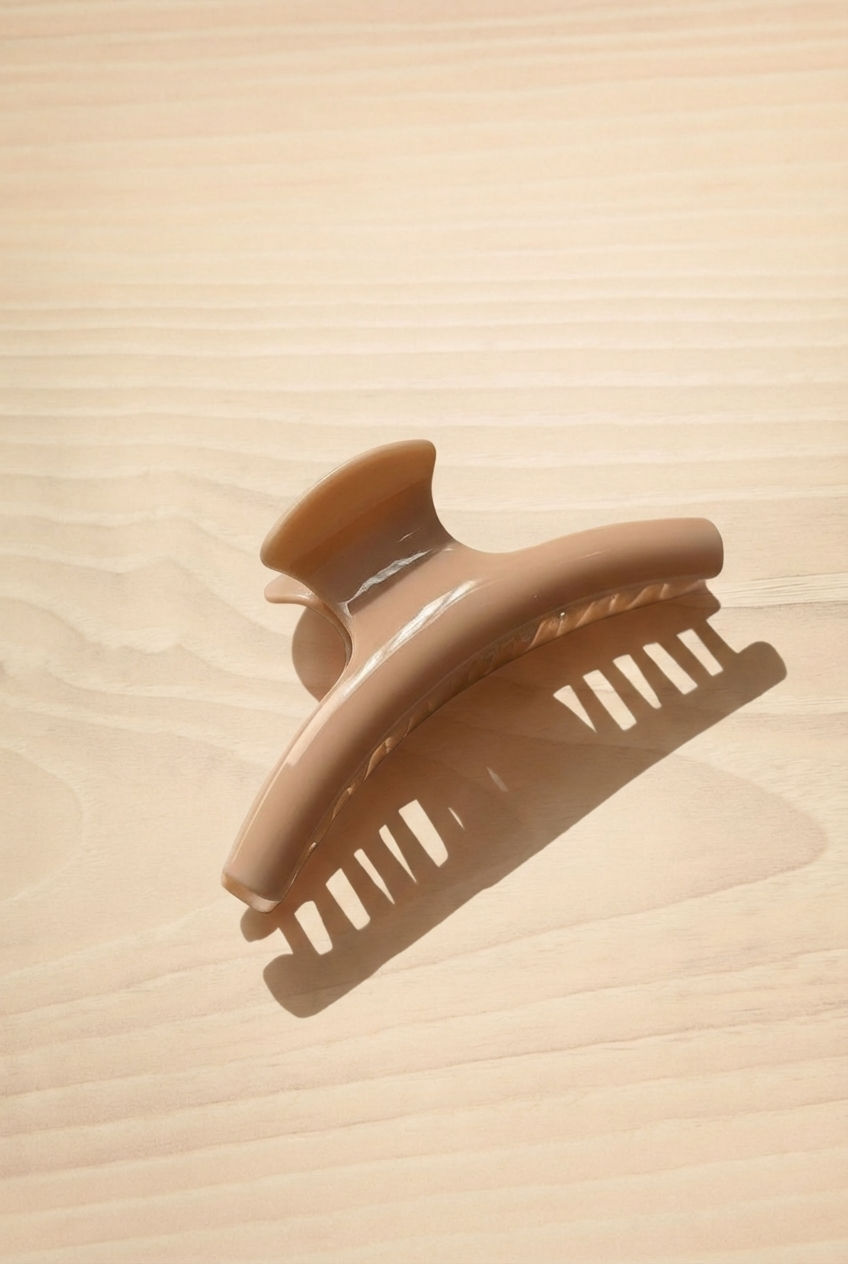 Biscuit Taupe hair clip on a wood background