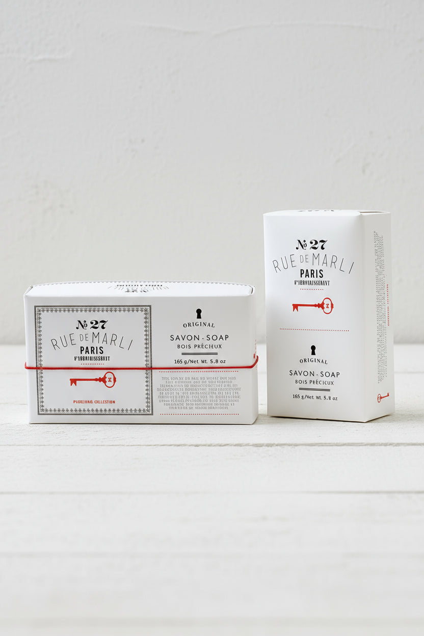 Two boxes of Rue de Marely soap on a white background
