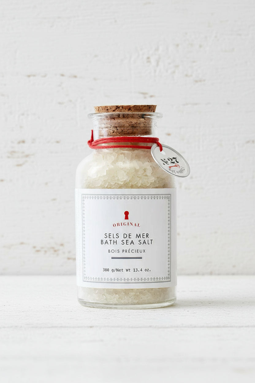 Bottle of bath sea salt with a label rue de marli on a white background