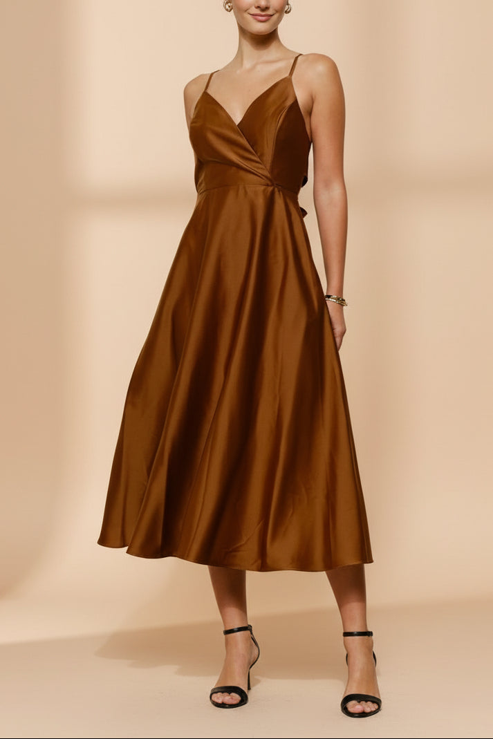 Front view of a woman wearing the Caryanne Brown Tie-Back Satin Dress from Boutique 1861