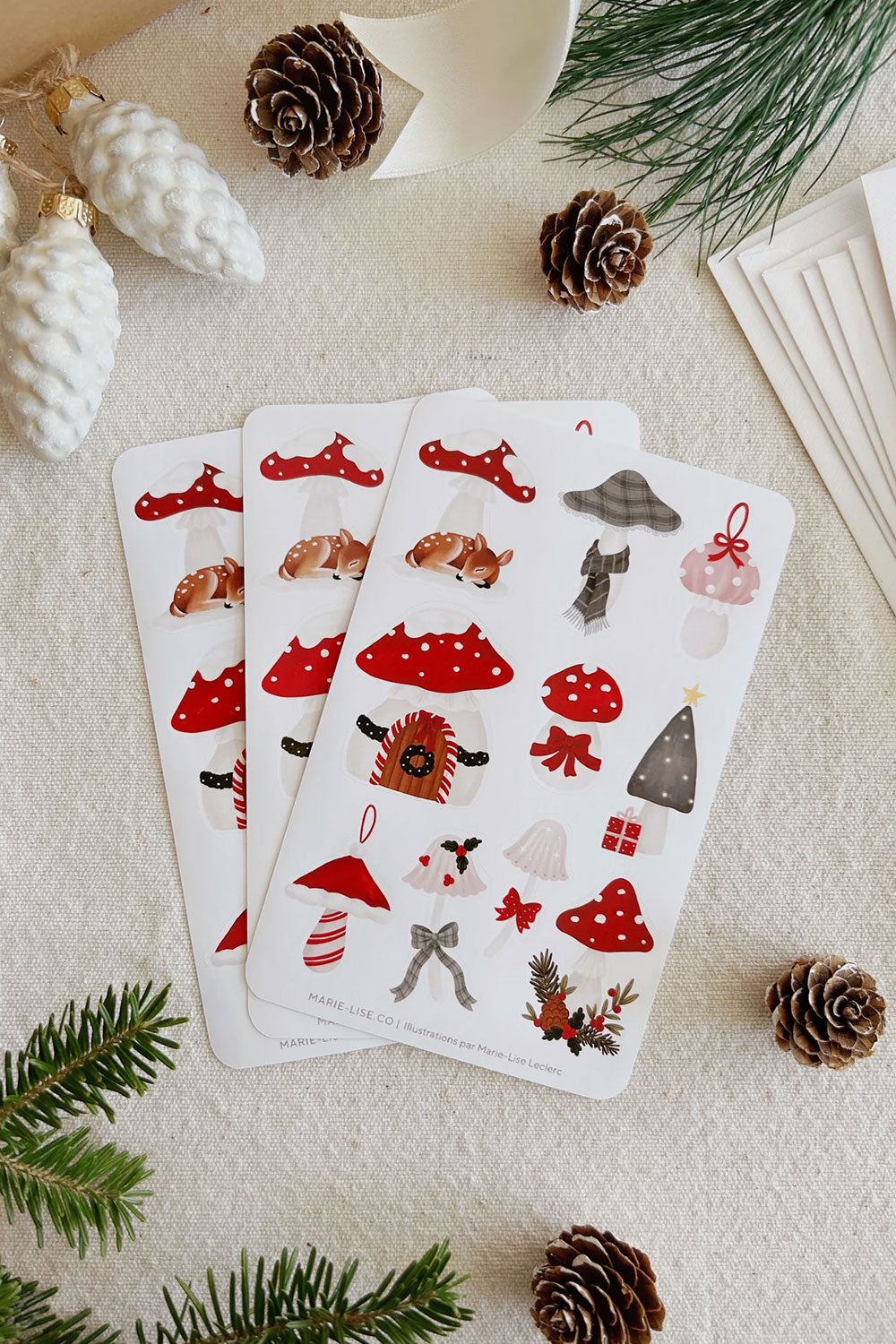 Two sheets of Christmas-themed stickers with various mushroom designs from Marie Lise illustration
