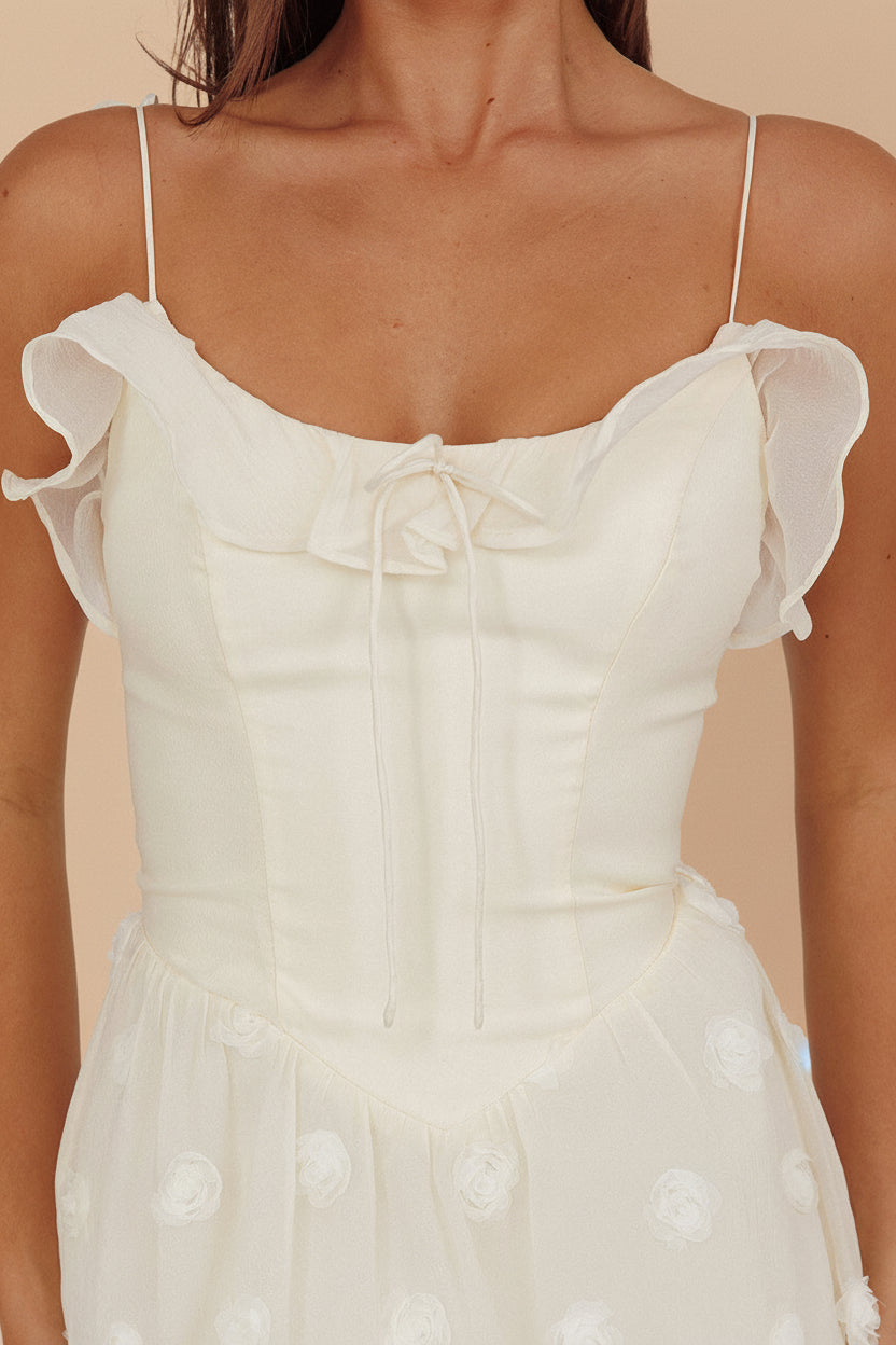 close-up of a woman wearing Claribel Cream Midi Dress with Floral-Embellishment from Boutique 1861