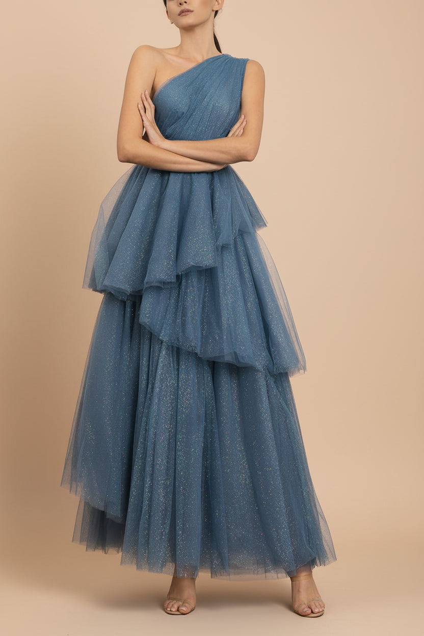 front of a woman wearing Cody Blue Grey Maxi One Shoulder Dress with Glitters fromt Boutique 1861