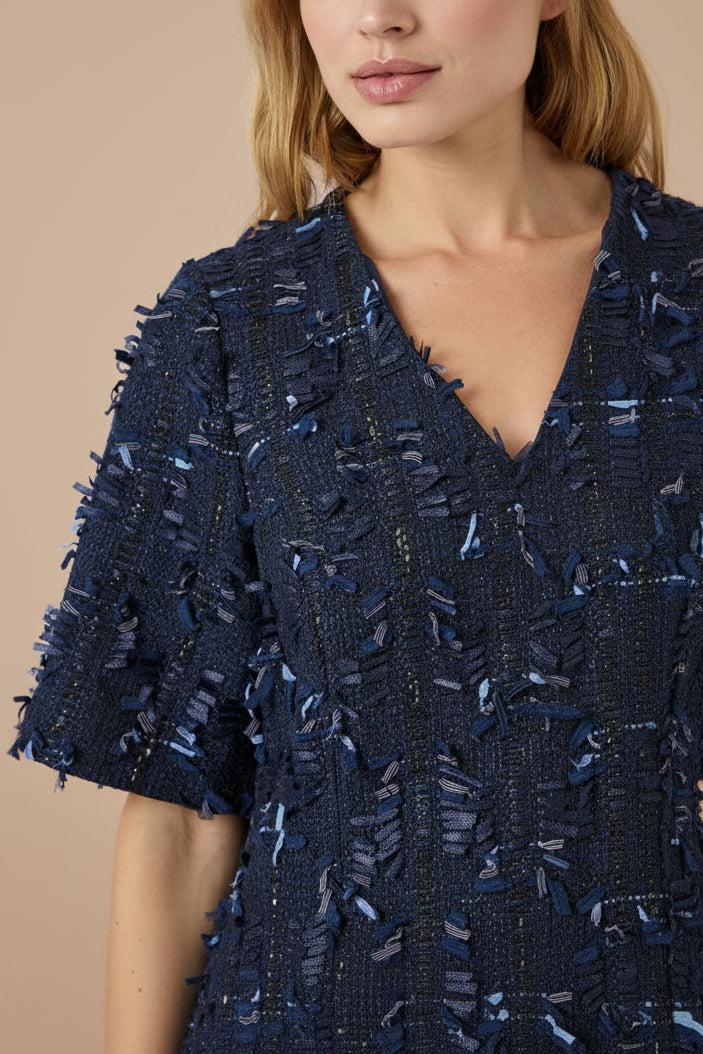 close-up of a woman wearing Coralyne Navy Tweed V-Neck Mini Dress from Boutique 1861