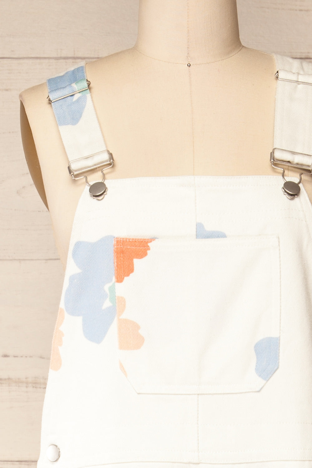 Claudius White Floral Denim Overalls | La petite garçonne front close-up