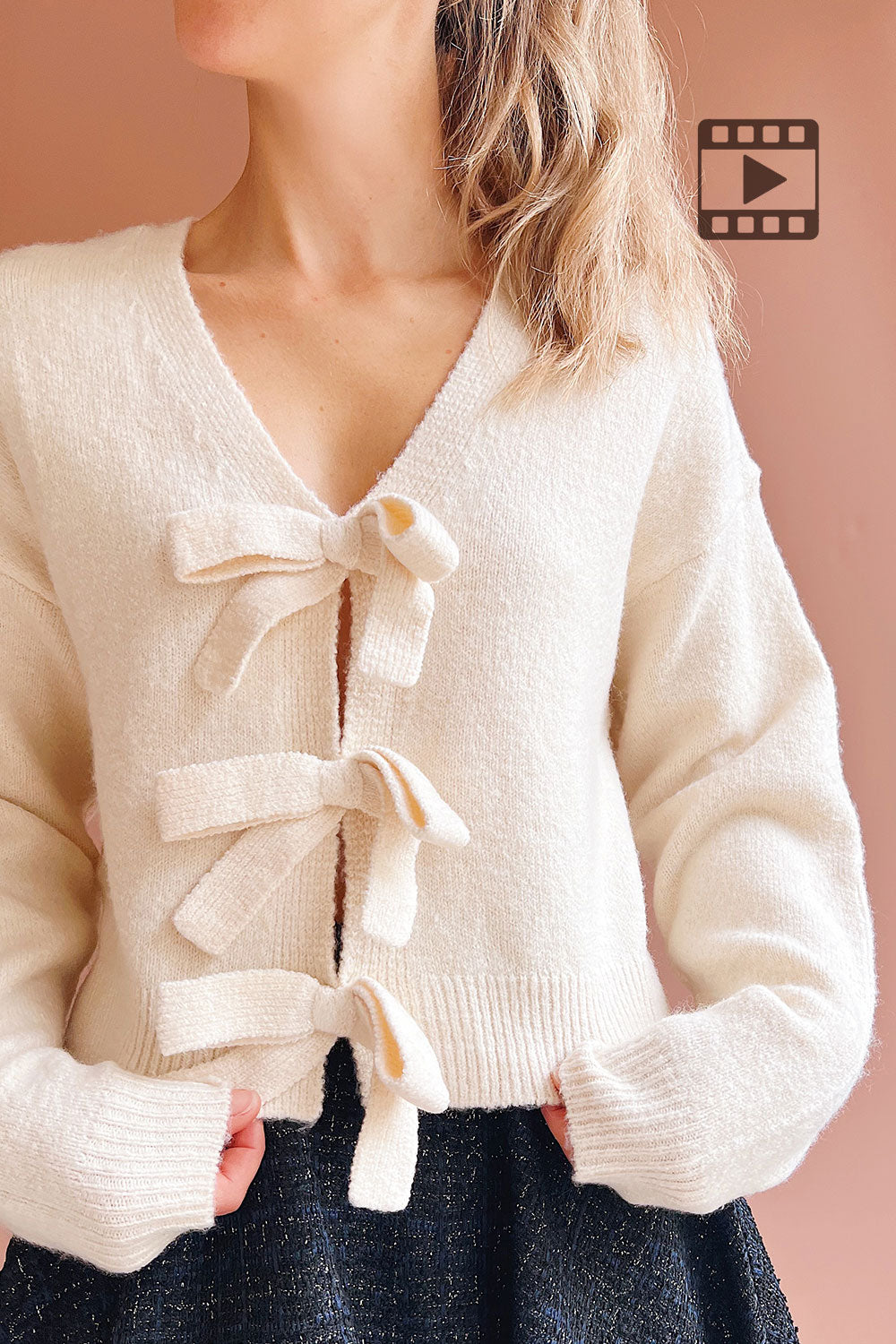 Person wearing Cassiopee Beige Cardigan with Bows from Boutique 1861