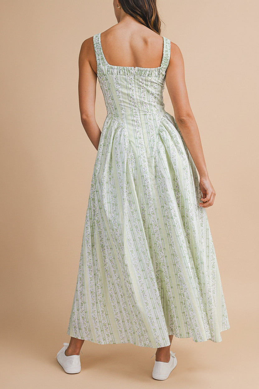 back view of a woman wearing Daiko Green Floral A-Line Maxi Dress with Corset Bust from Boutique 1861