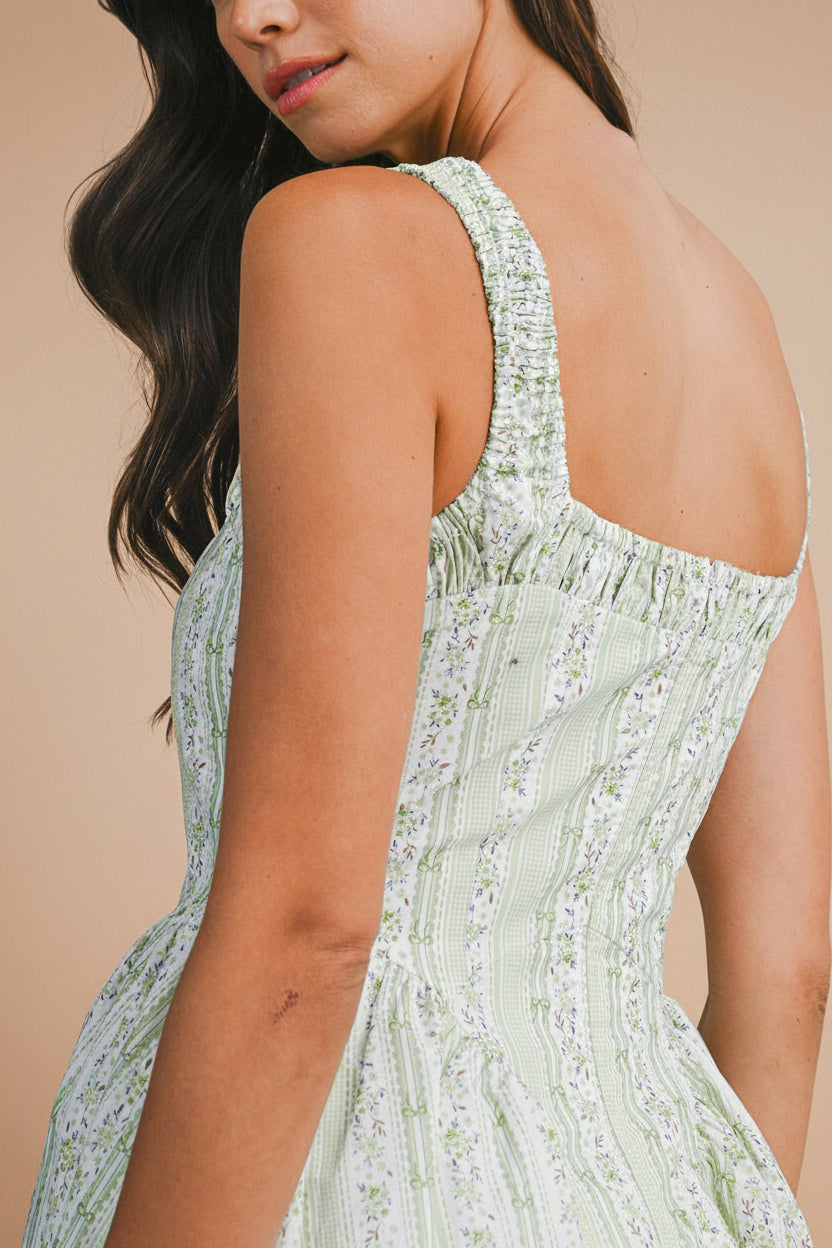 back close-up of a woman wearing Daiko Green Floral A-Line Maxi Dress with Corset Bust from Boutique 1861