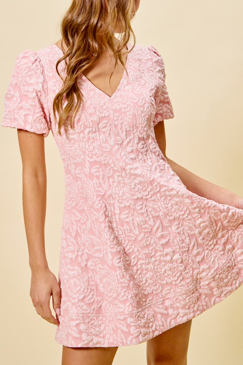 woman wearing Deedee Pink Floral Short Dress with Puff Sleeves from Boutique 1861 front view