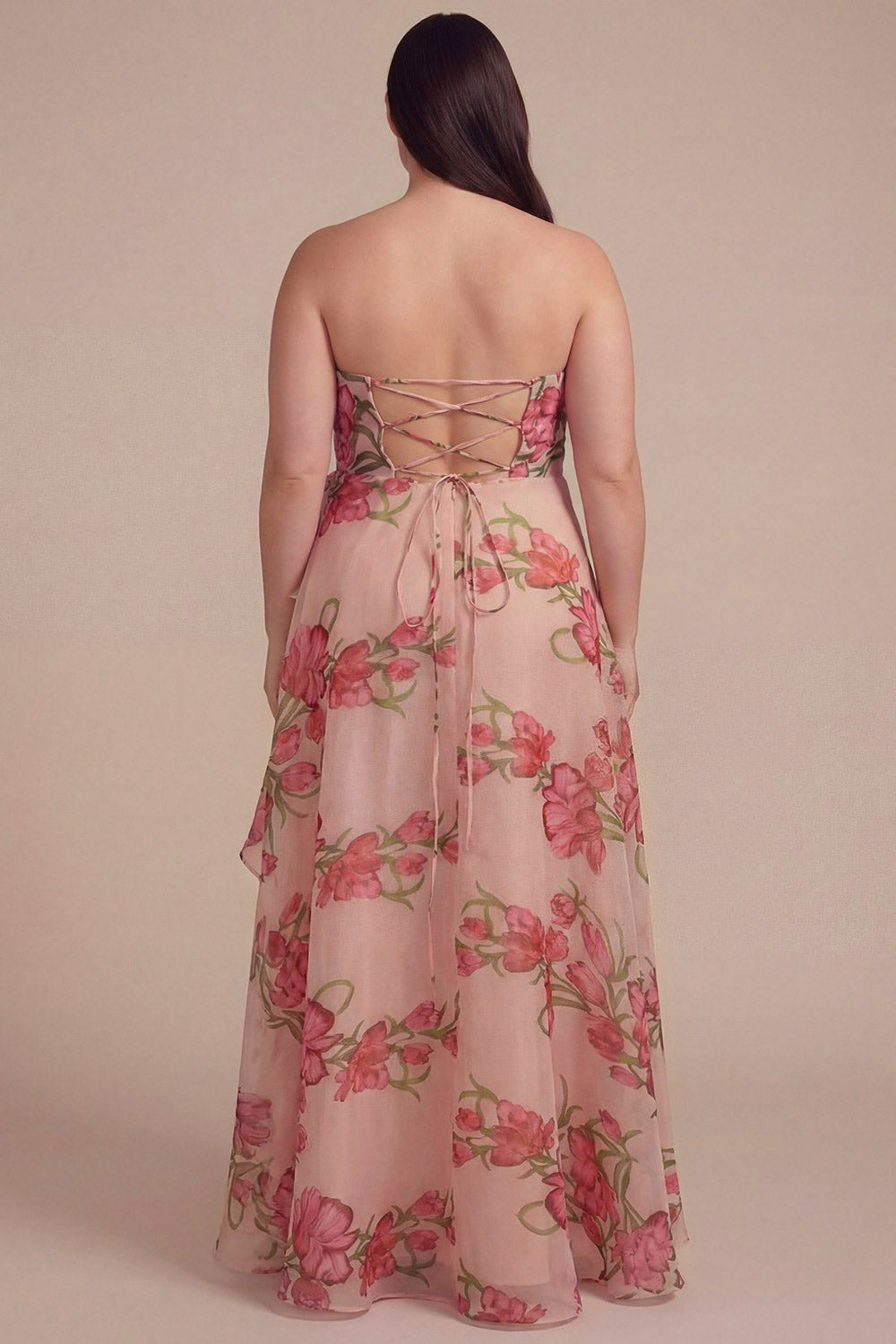 back of a plus size woman wearing Delora Floral Organza Ruffled Maxi Dress with Front Slit and Lace-Up Corset from Boutique 1861