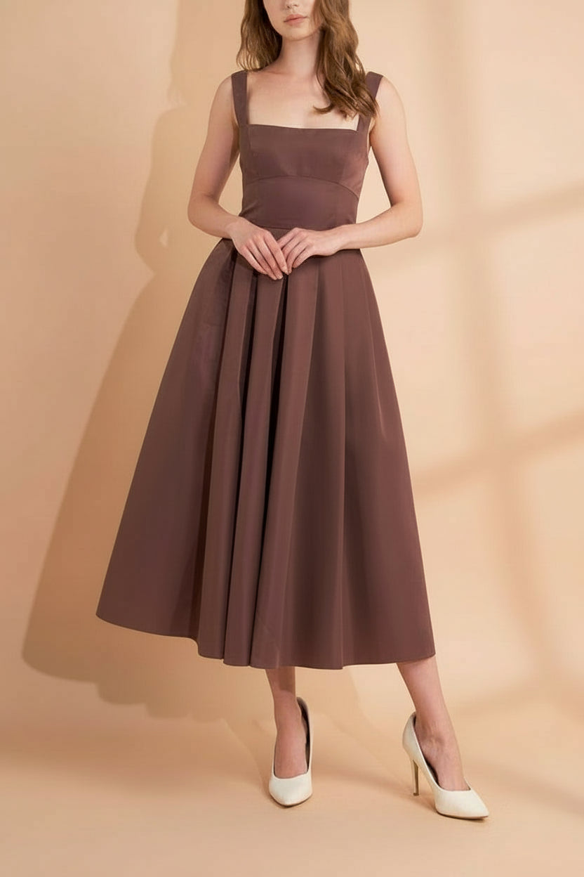 Brown dress Edwina worn front view by a model on a beige background