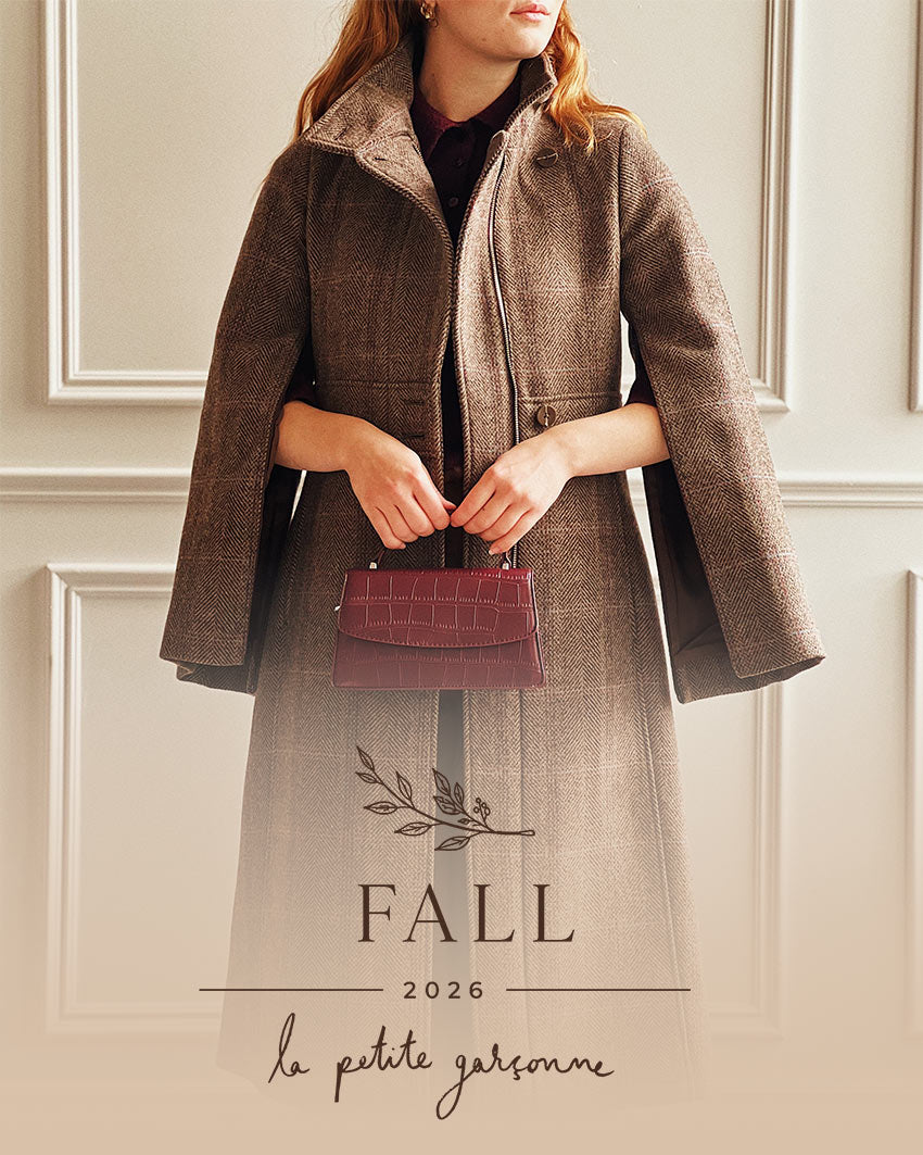 Woman wearing a brown coat and burgundy handbag from La Petite Garçonne