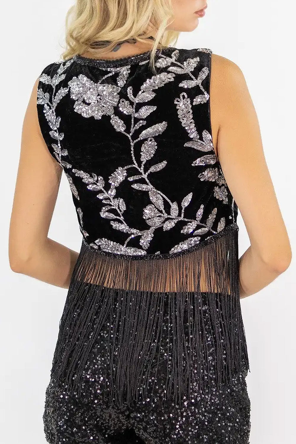 Back view of a woman wearing the Elna black velvet vest with fringes from Boutique 1861.