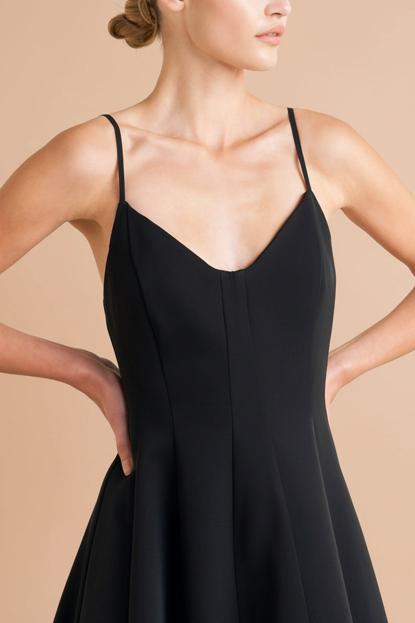 close-up of a woman wearing Hariette Black A-Line Midi Dress with V-Neck from Boutique 1861