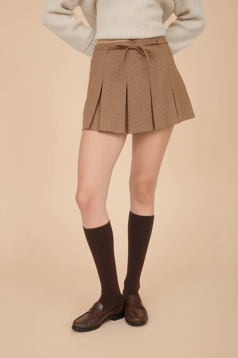 view of a woman wearing Kohima Brown Houndstooth Mini Skirt with Built in Shorts from La petite garçonne