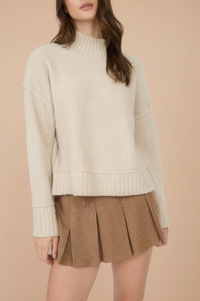 front of a woman wearing Kohima Brown Houndstooth Mini Skirt with Built in Shorts from La petite garçonne