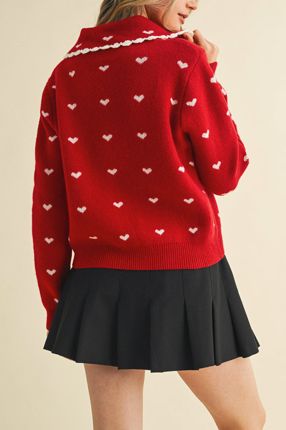 back view of a woman wearing Kristeen Red Knit Cardigan with Heart Pattern from Boutique 1861