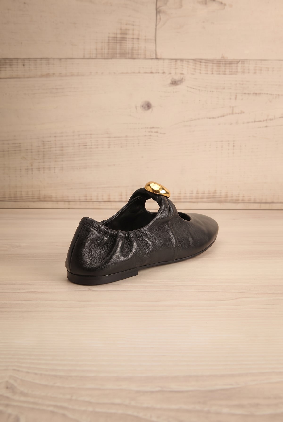back view of Kornela Black Leather Ballet Flat Shoes at La petite garçonne