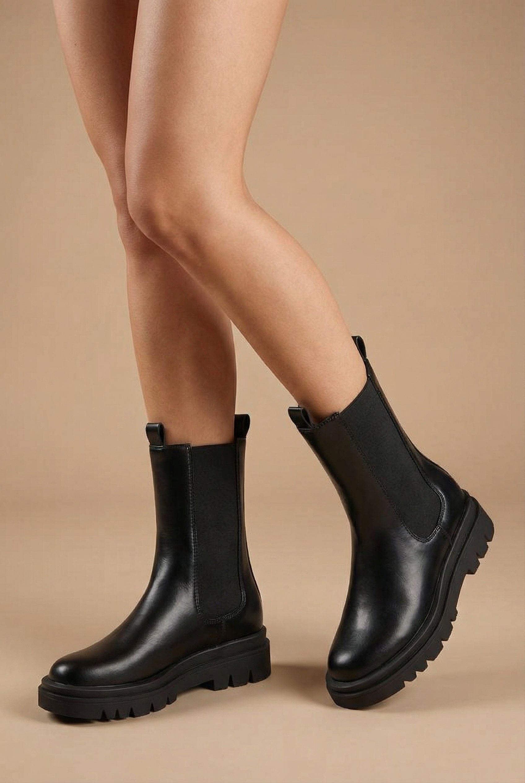 woman wearing Lommel Black Rain Boots from La petite garçonne back platform