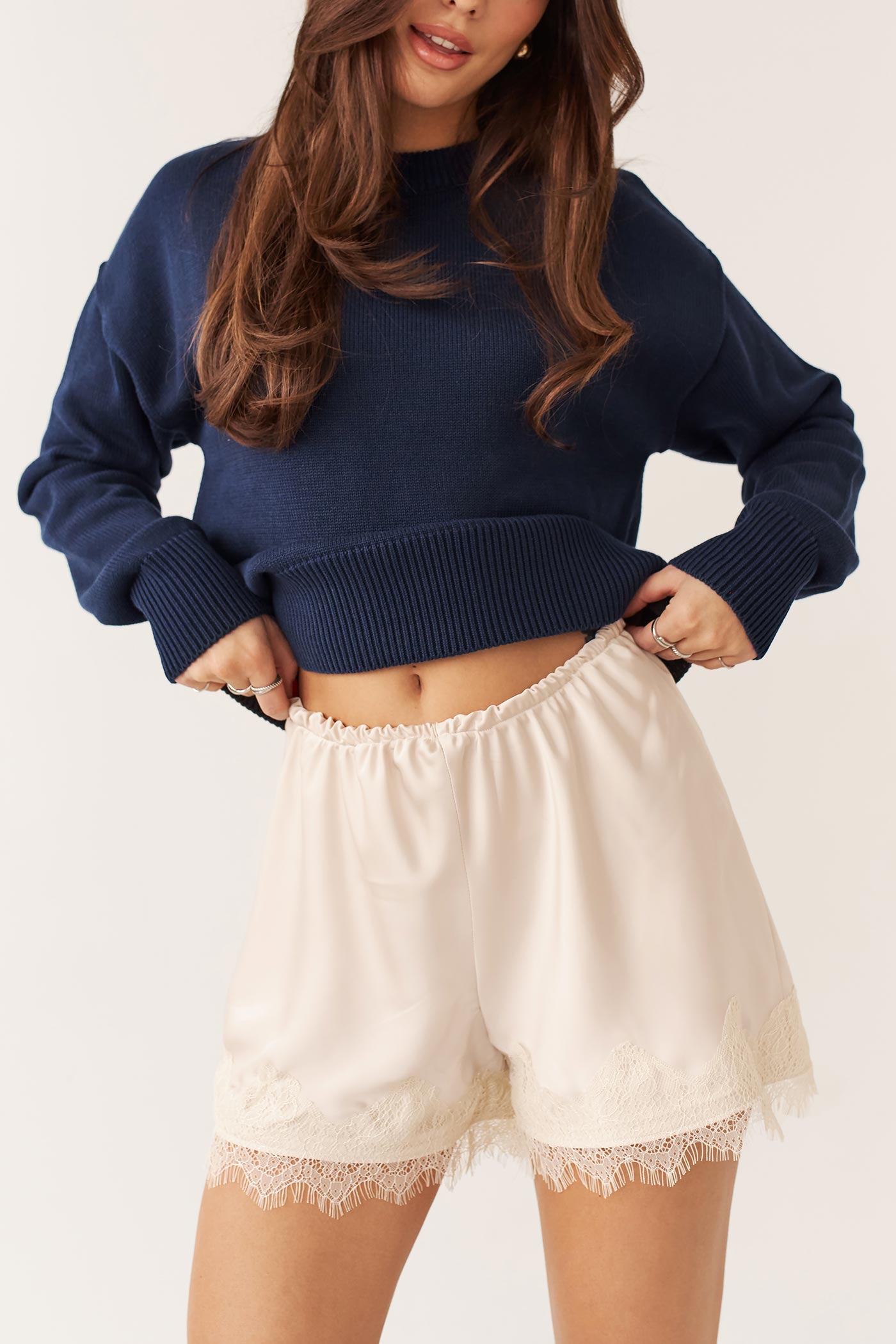 close-up of a woman wearing Lyna Shorts Ivory Satin Lace Trim Shorts by Dailystory from La petite garçonne