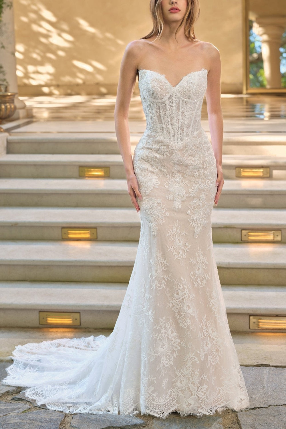 Woman wearing Maelie, a strapless lace wedding dress with corset from Boudoir 1861