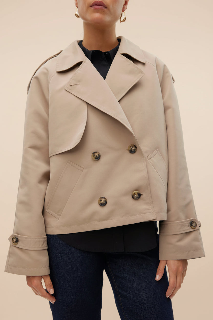 front of a woman wearing Manduria Short Trench Coat from La petite garçonne