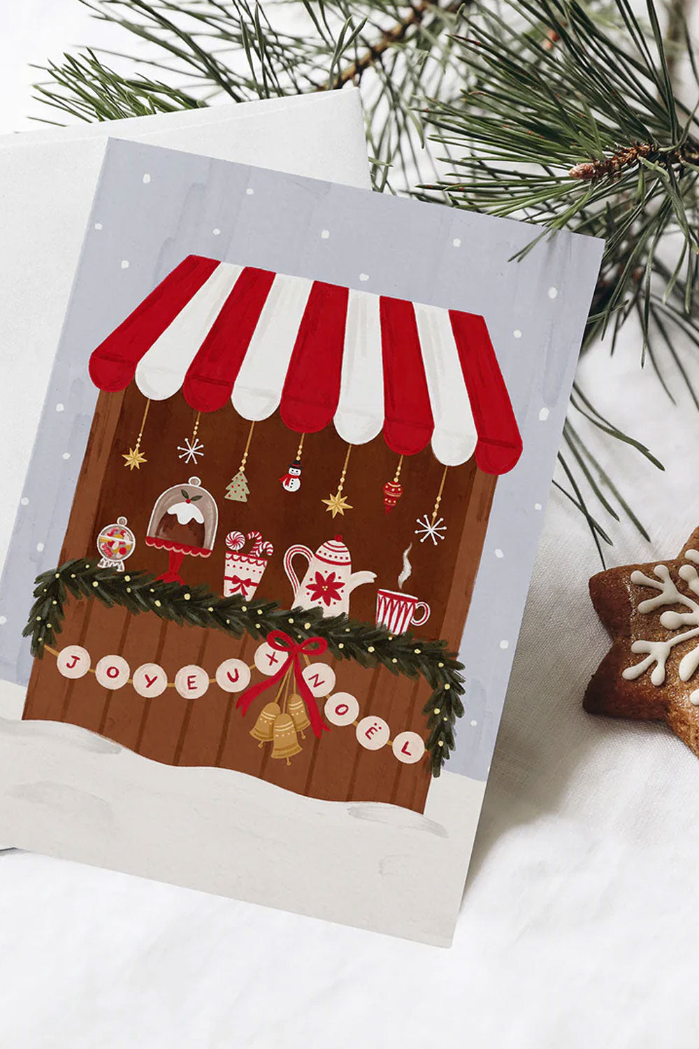 Christmas-themed card with a festive German market stall design on a snowy background.
