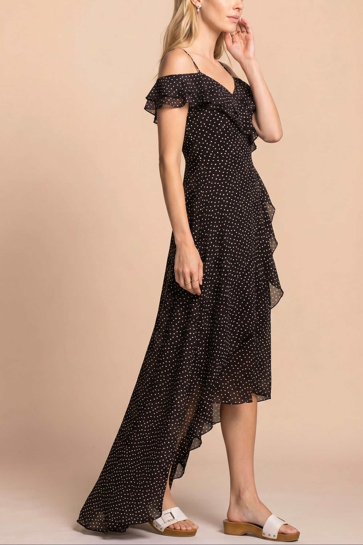 side view of a woman wearing Maralda Black Maxi Dress with Polka Dots from Boutique 1861