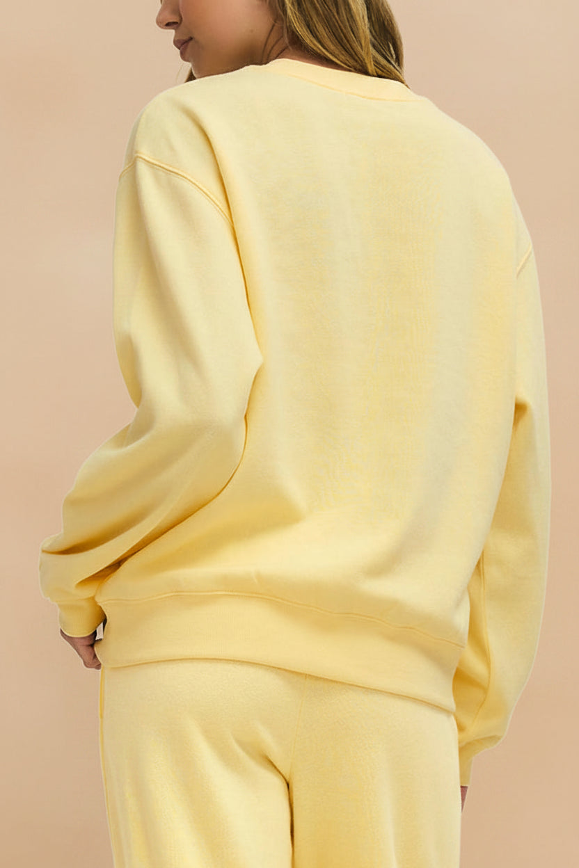 back view of a woman wearing Nesna Yellow Oversized Sweatshirt from La petite garçonne