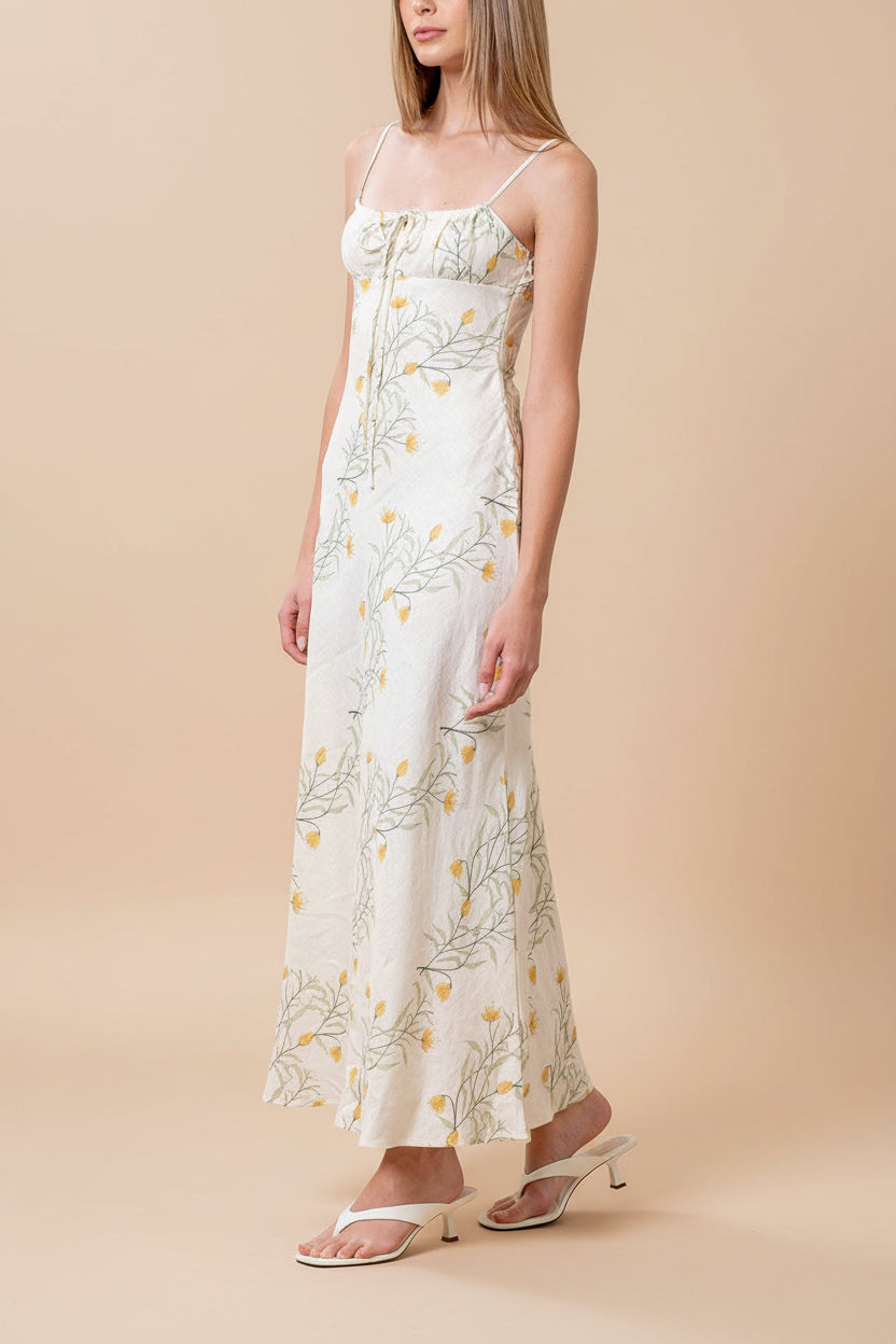side of a woman wearing Nevan Ivory Floral Midi Dress with Front Tie Detail from Boutique 1861