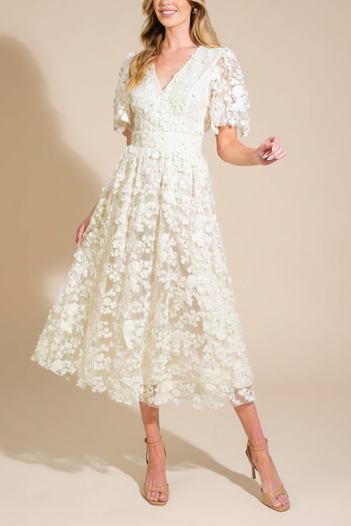 Frontview of a Woman wearing Oukie Ivory, a Midi Floral Lace Dress from Boudoir 1861