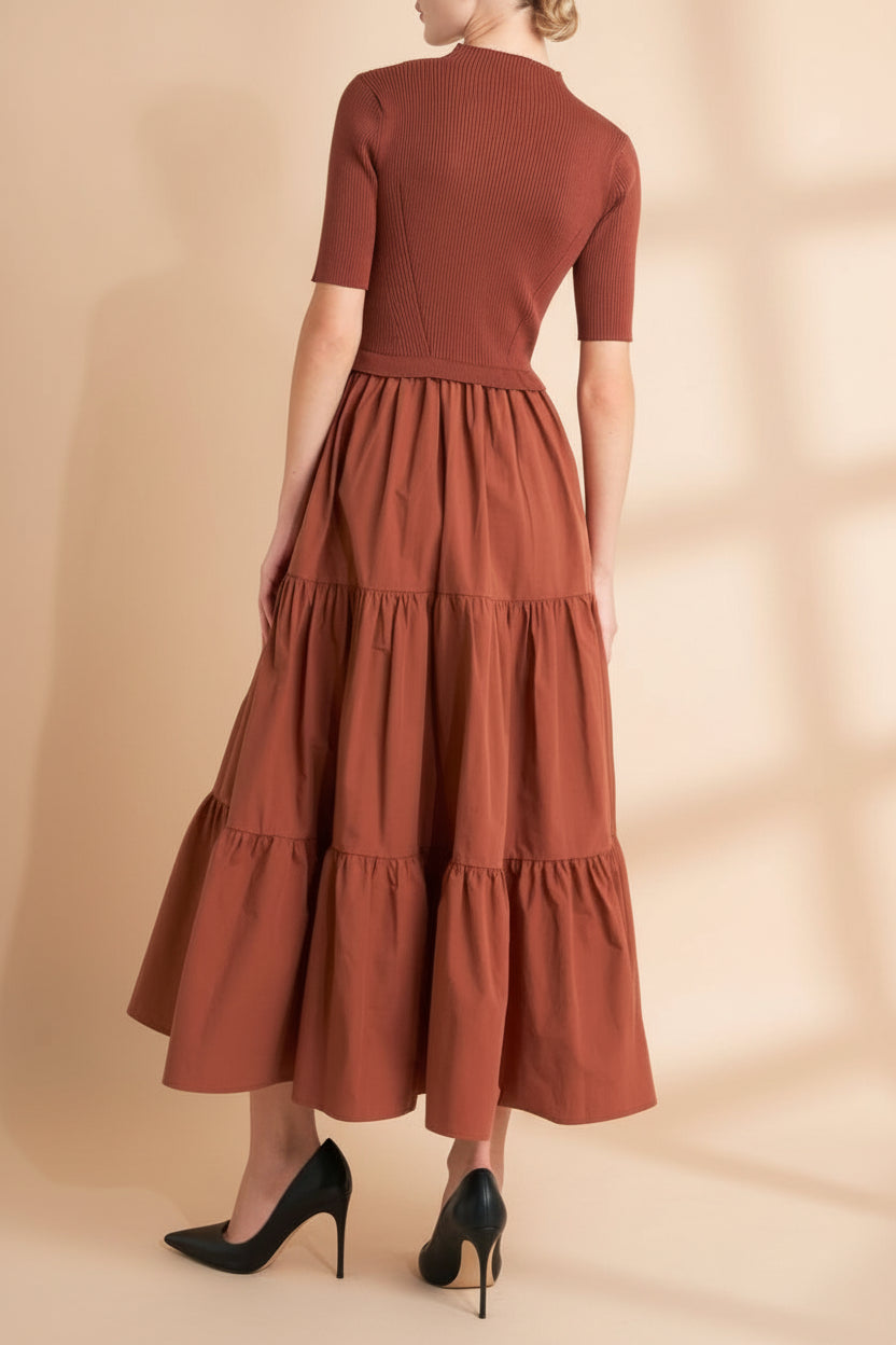 Back view of a woman wearing the Penrith Rust Mock Neck Midi Dress from boutique 1861