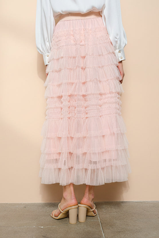 front view of a woman wearing Poema Blush Tiered Tulle Maxi Skirt from Boutique 1861