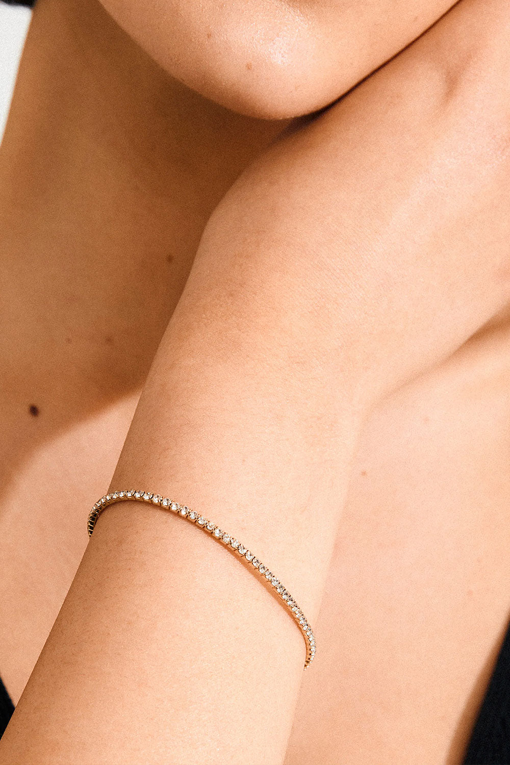 Close-up of woman wearing a Gold bracelet ARASH from Pilgrim available at La petite garçonne in Montreal
