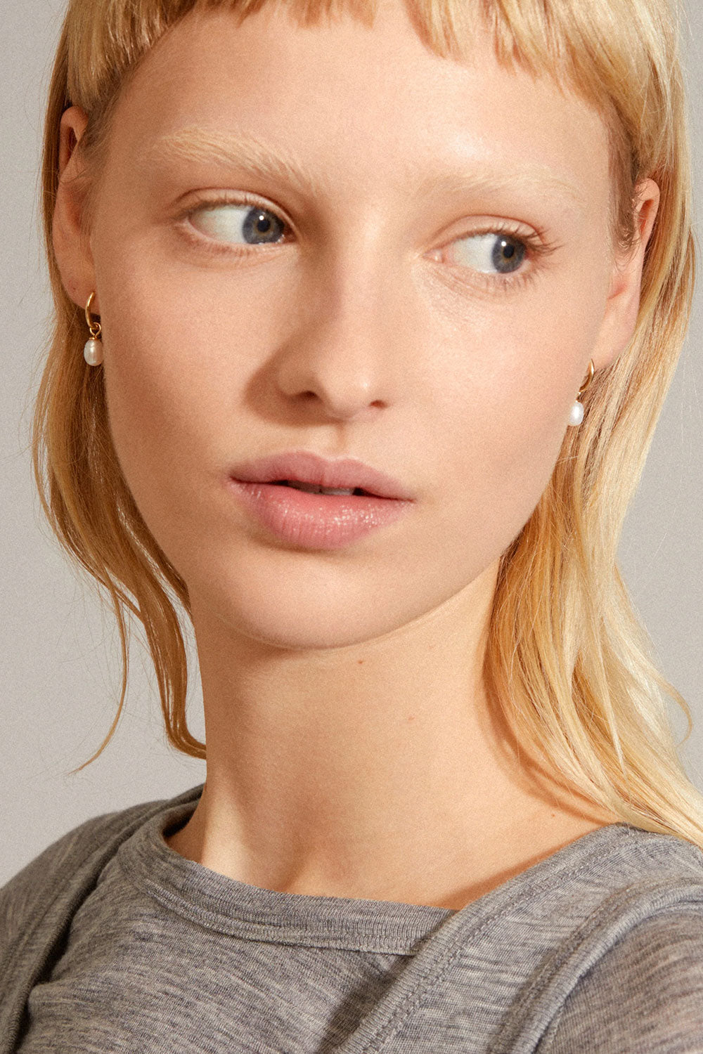 Photo of a woman wearing a gold earring BOKARO from Pilgrim available at la petite garçonne in Montreal.