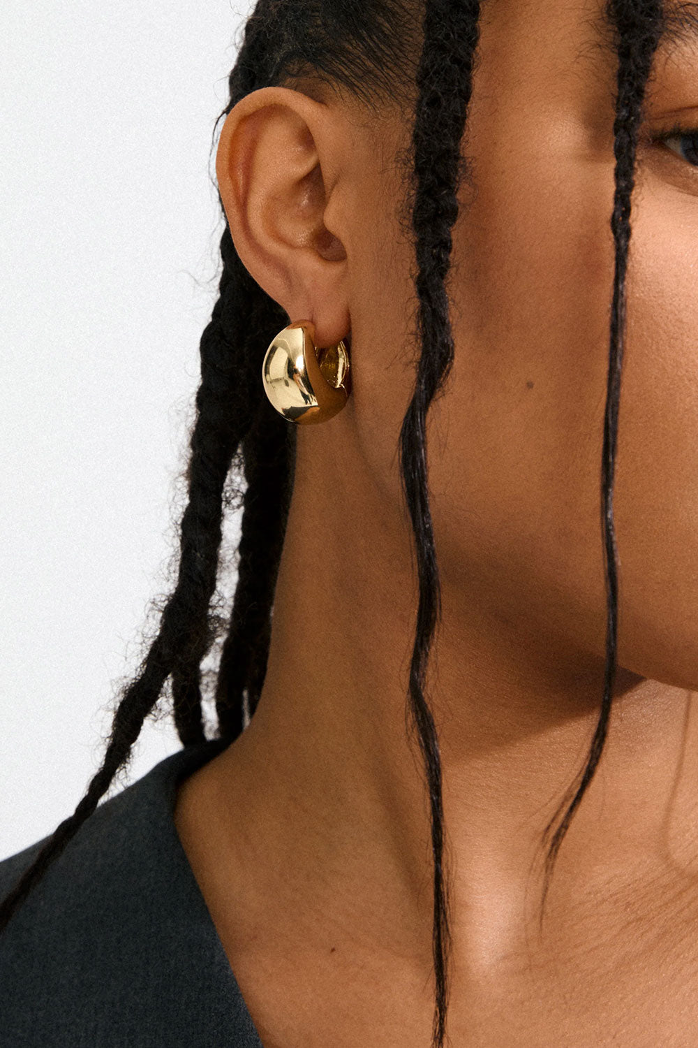 Photo of a woman wearing a gold hoop earring Besi from Pilgrim available at la petie garçonne in Montreal.