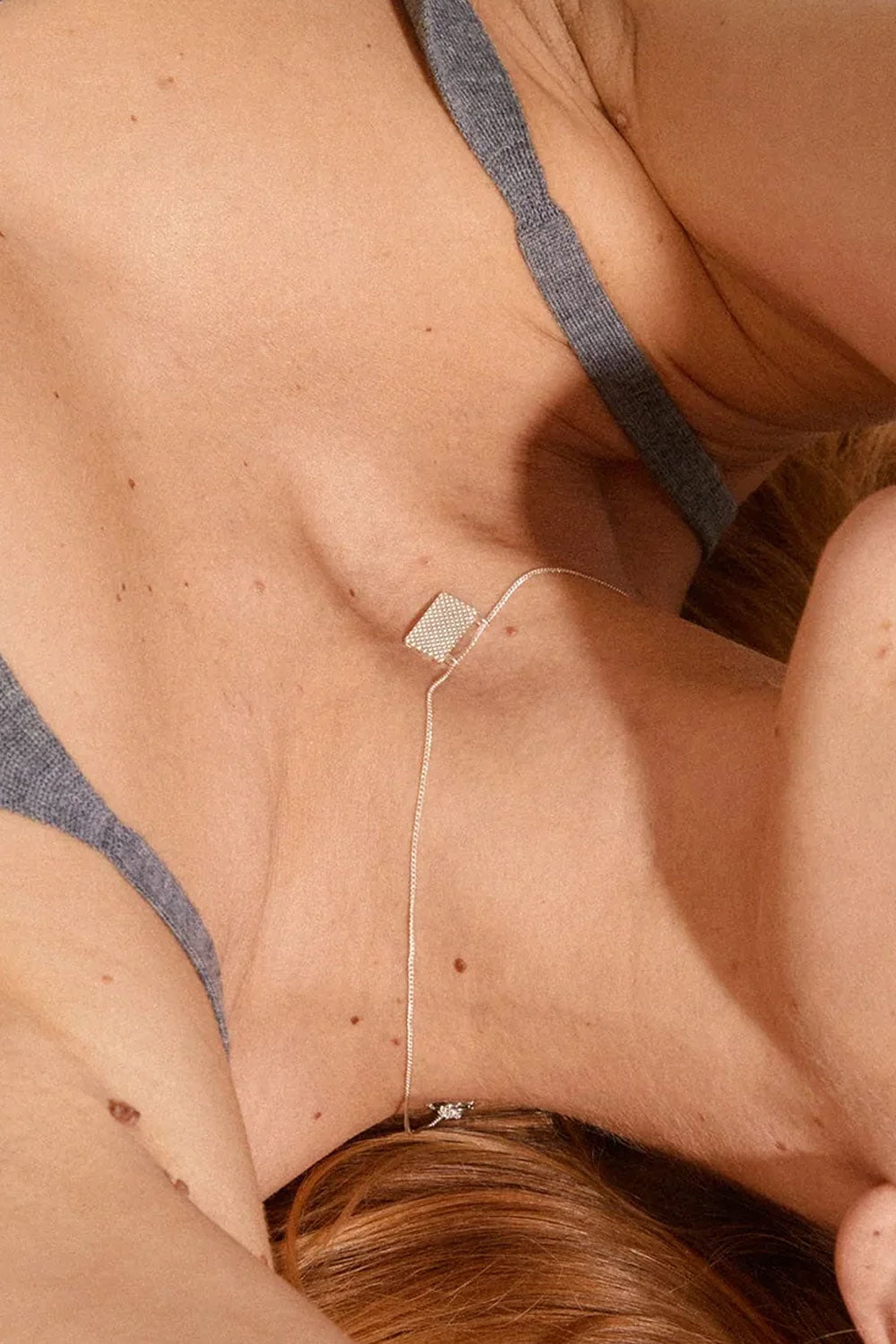 Close-up of a person wearing Pulse by Pilgrim, a delicate gold necklace with a geometric pendant available at la petite garçonne in Montreal
