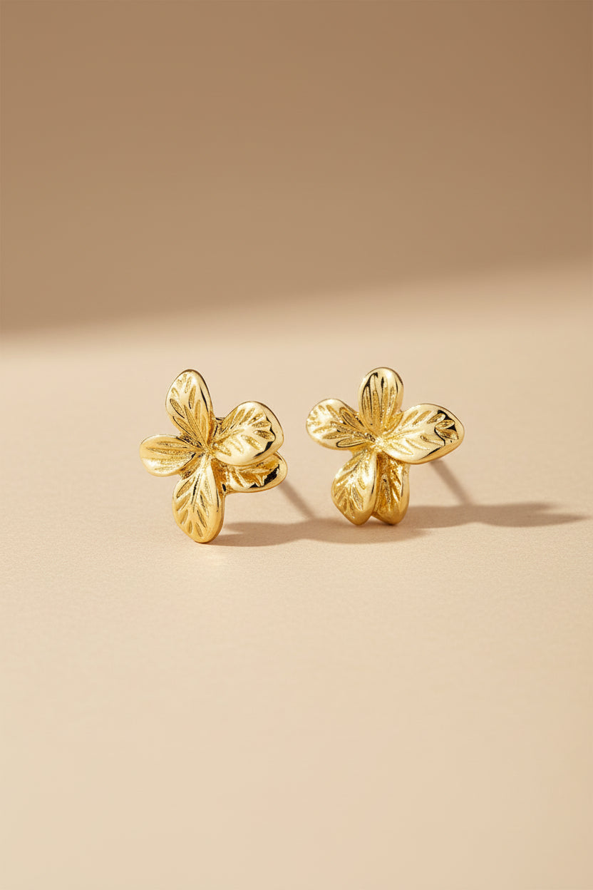 Close-up of Charmaine from Pilgrim, a gold flower earring available at la petite garçonne in Montreal.
