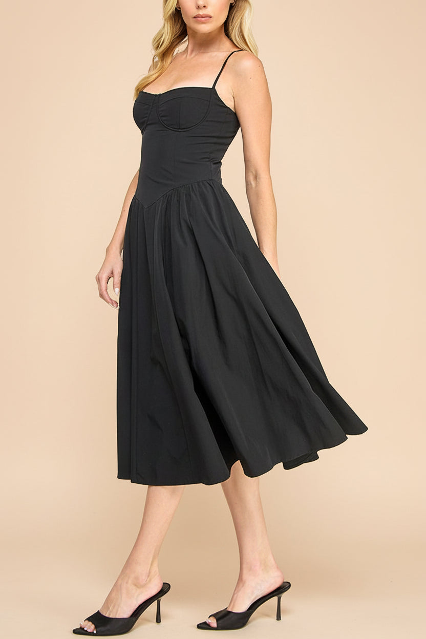 side view of a woman wearing Rhonda Black Bustier Midi Dress with Flared Skirt from Boutique 1861